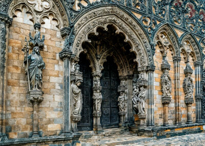 Intricately carved Gothic church entrance with detailed stone sculptures.