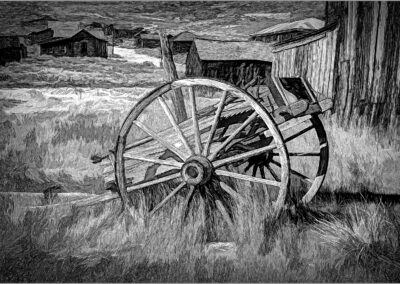 Black and white sketch of an old wagon wheel in a field.