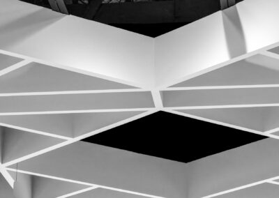 Modern geometric ceiling design with illuminated rectangular shapes.