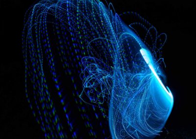 Abstract blue light trails forming a dynamic shape on black background.