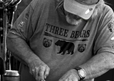 Man wearing a 'Three Bears' shirt working with tools.