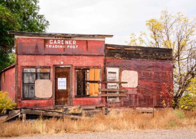 Abandoned rustic train depot in a rural setting during fall.