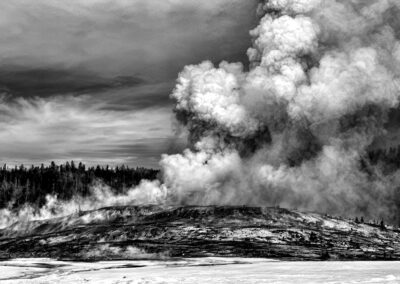 Black and white image of a volcanic eruption with dense smoke and steam.