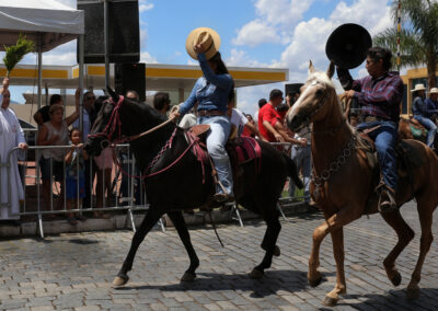 People riding horses in a parade with spectators watching.
