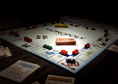 Classic Monopoly board game setup with houses, dice, and money.
